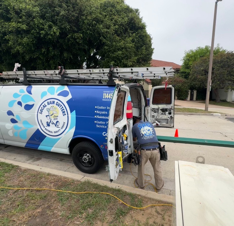 SoCal Rain Gutters work van with ladders on the roof rack, parked at a job in the Los Angeles area