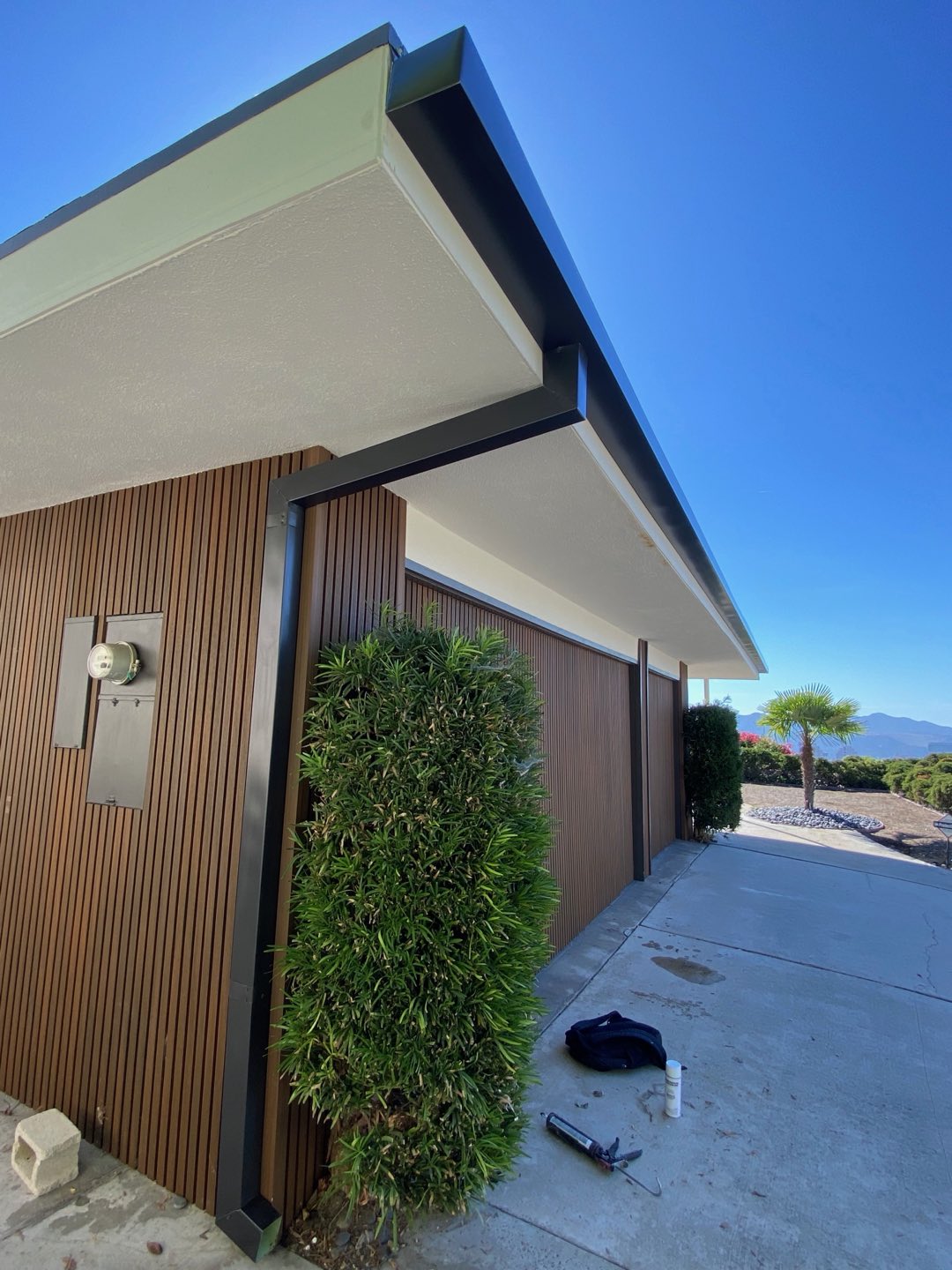 Dark bronze box gutter and square downspout on a mid-century home in the Los Angeles area